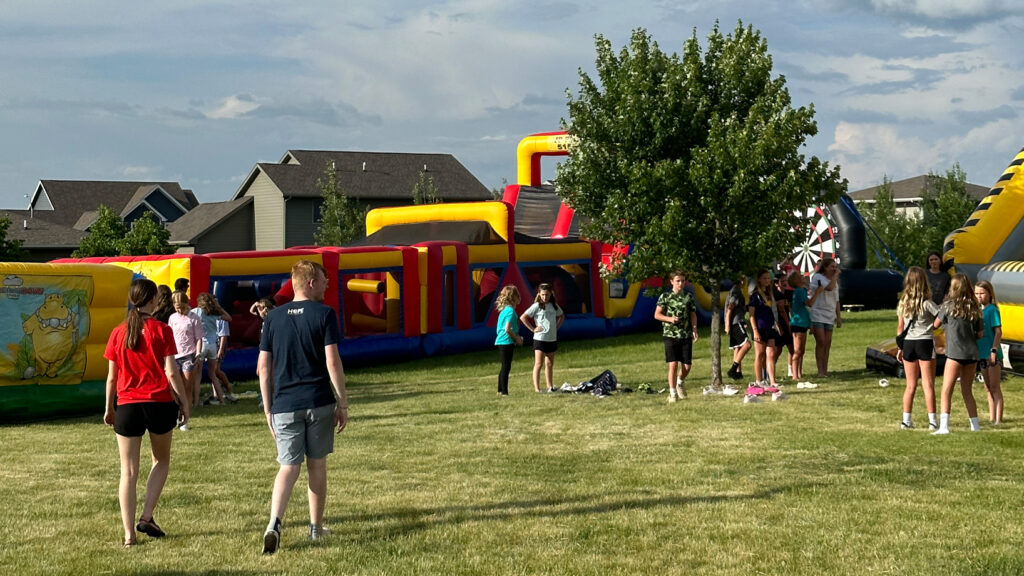 students walking outside toward inflatables 