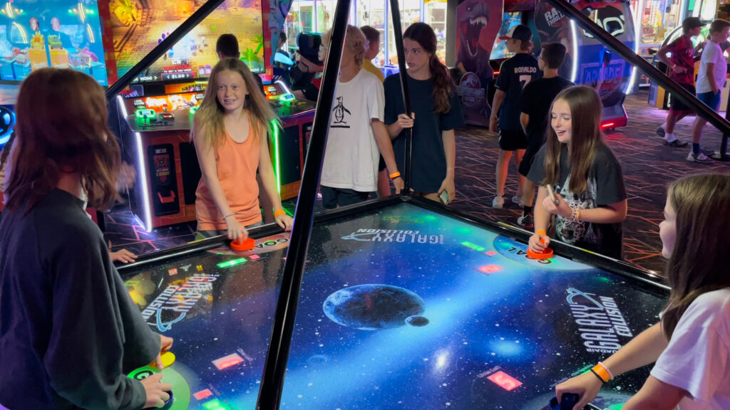 students at Spare Time playing air hockey