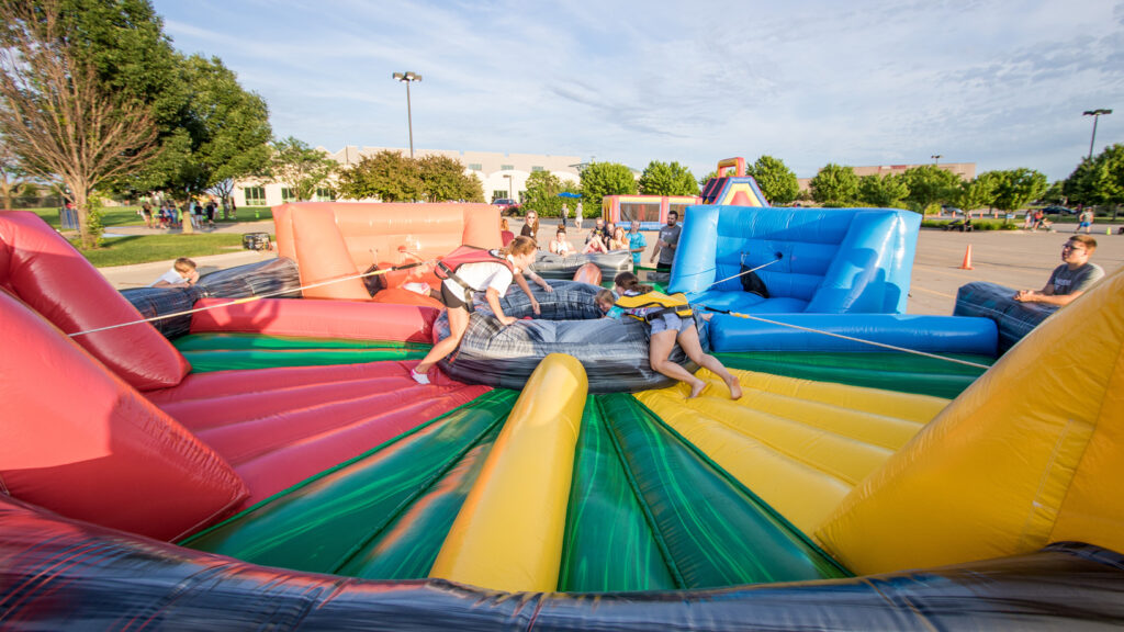 students playing on inflatable outside