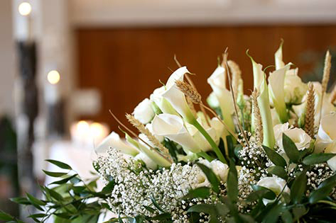 Flowers on an altar in the church and the candles on background